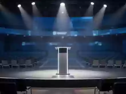 Ein leeres Podium auf einer modernen Technologiekonferenz-Bühne in einem abgedunkelten, professionellen Auditorium. - Foto: über boerse-global.de