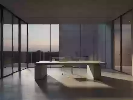 Ein minimalistischer, moderner Arbeitsbereich in einem architektonisch gestalteten Raum mit schlichten Linien und natürlichem Licht. - Foto: über boerse-global.de