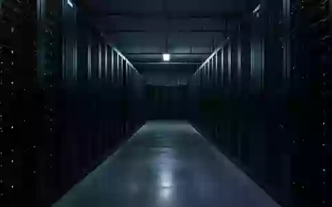 Ein dunkler, minimalistischer Serverraum mit unbeleuchteten Server-Racks und blauem Umgebungslicht. - Foto: über boerse-global.de