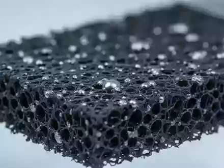 Nahaufnahme von Graphitfilz mit metallischen Nanostrukturen in einer Laborumgebung. - Foto: über boerse-global.de