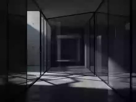 Ein minimalistischer, dunkel beleuchteter Flur mit geometrischen Schatten auf einem Betonboden. - Foto: über boerse-global.de