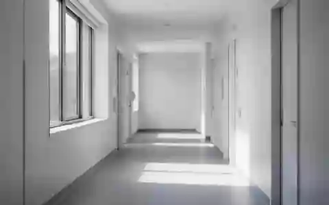 Ein leerer, heller Krankenhausflur mit minimalistischer Architektur und sanftem Tageslichteinfall. - Foto: über boerse-global.de