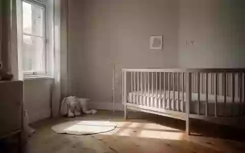 Minimalistisch eingerichtetes Kinderzimmer mit sanftem Tageslichteinfall auf einem Holzboden. - Foto: über boerse-global.de