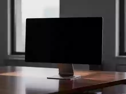 Ein minimalistischer, dunkel gehaltener Arbeitsplatz mit einem ausgeschalteten Monitor in einer ruhigen Büroumgebung. - Foto: über boerse-global.de