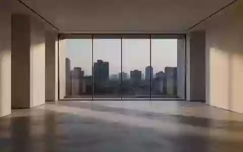 Ein minimalistischer, lichtdurchfluteter Raum mit poliertem Betonboden und Blick auf eine ruhige Skyline bei Dämmerung. - Foto: über boerse-global.de