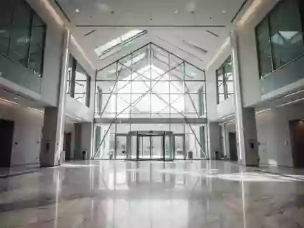 Innenansicht eines modernen, minimalistischen Bankgebäudes mit reflektierenden Marmorböden und architektonischen Glasflächen. - Foto: über boerse-global.de