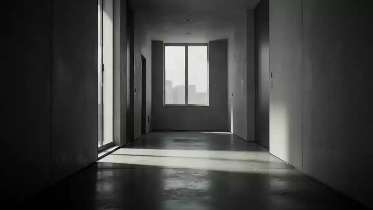 Ein minimalistischer, leerer Flur mit natürlichem Lichteinfall und Schattenwurf auf einem Betonboden. Illustration mit AI erstellt.