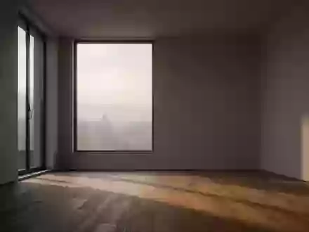 Ein minimalistischer, leerer Raum in den frühen Morgenstunden mit sanftem, diffusem Licht und langen Schatten auf einem Holzboden. - Foto: über boerse-global.de