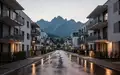Moderne Wohngebäude in Bregenz vor einer alpinen Kulisse in der Dämmerung. - Foto: über boerse-global.de