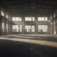 Eine leere, weitläufige Industriehalle mit Betonboden und hohen Fenstern, die lange Schatten wirft. - Foto: über boerse-global.de