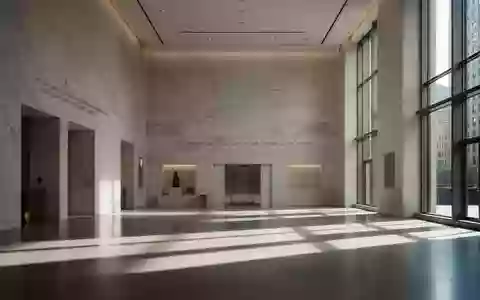Ein minimalistisch gestalteter, lichtdurchfluteter Flur in einem modernen Regierungsgebäude mit klaren architektonischen Linien. - Foto: über boerse-global.de