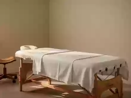 Ein minimalistischer, heller Behandlungsraum mit einer professionellen Massageliege in einer ruhigen, klinischen Umgebung. - Foto: über boerse-global.de