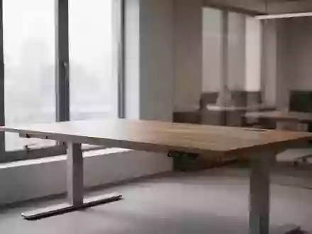 Ein leerer, ergonomischer Arbeitsplatz mit einem höhenverstellbaren Schreibtisch in einem hellen, ruhigen Büro. - Foto: über boerse-global.de