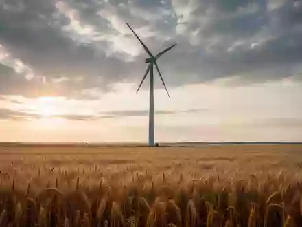 Ein modernes Windrad in einem sonnendurchfluteten Weizenfeld bei Sonnenuntergang. - Foto: über boerse-global.de