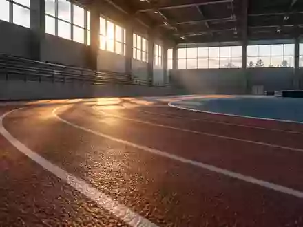 Eine leere, modern gestaltete Leichtathletikbahn in sanftem Tageslicht, die Fokus auf die Textur der Sportanlage legt. - Foto: über boerse-global.de