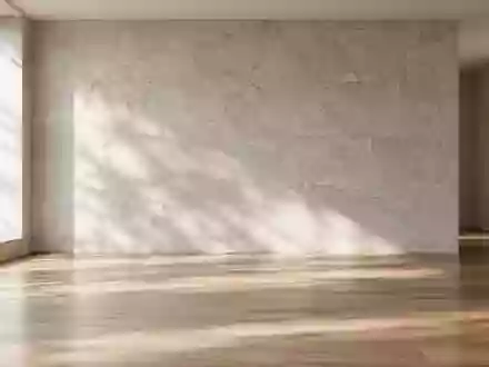 Ein minimalistischer, lichtdurchfluteter Raum mit sanften Schatten auf einer Steinwand, der Ruhe und Ausgeglichenheit vermittelt. - Foto: über boerse-global.de