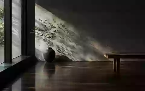 Minimalistisches Interieur mit tiefen Schatten und natürlichem Licht, das eine architektonische Textur betont. - Foto: über boerse-global.de