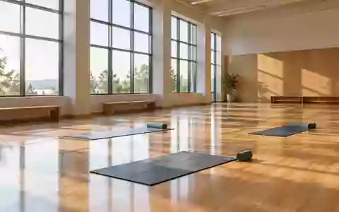 Ein heller, leerer Gymnastikraum mit Holzboden und Yoga-Matten in einer ruhigen, lichtdurchfluteten Umgebung. - Foto: über boerse-global.de