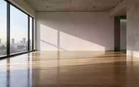 Ein minimalistischer, leerer Büroraum mit hellem Holzboden und natürlichem Lichteinfall durch ein großes Fenster. - Foto: über boerse-global.de