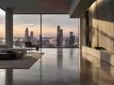 Ein minimalistischer, moderner Innenraum mit klaren geometrischen Linien und natürlichem Licht, das auf einen Betonboden fällt. - Foto: über boerse-global.de