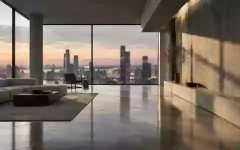 Ein minimalistischer, moderner Innenraum mit klaren geometrischen Linien und natürlichem Licht, das auf einen Betonboden fällt. - Foto: über boerse-global.de
