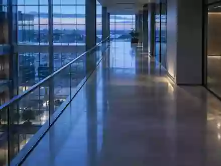 Ein minimalistischer, leerer Büroflur in einem modernen Gebäude mit kühlem, blauem Licht und klaren architektonischen Linien. - Foto: über boerse-global.de