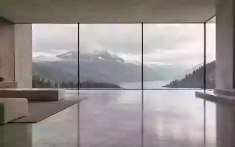 Ein minimalistischer, heller Innenraum mit weichem Tageslicht und Blick auf eine ruhige Berglandschaft. - Foto: über boerse-global.de