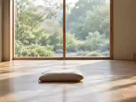 Ein ruhiger, minimalistischer Raum mit natürlichem Licht, einem einzelnen Meditationskissen auf einem Holzboden und Blick in einen Garten. - Foto: über boerse-global.de