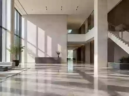 Ein minimalistisches, modernes Bürogebäude mit hohen Decken und geometrischen Linien bei natürlichem Lichteinfall. - Foto: über boerse-global.de