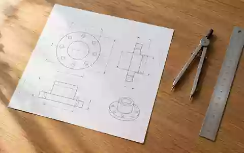 Ein minimalistischer Arbeitsplatz mit einem offiziellen Dokument, einem Zirkel und einem Lineal auf einem Holztisch. - Foto: über boerse-global.de