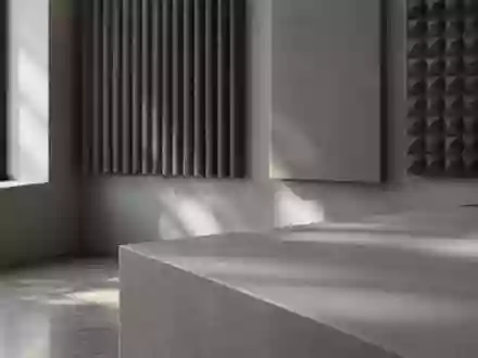 Ein minimalistisches, professionelles Tonstudio mit akustischen Wandpaneelen in neutralen Grautönen bei natürlichem Licht. - Foto: über boerse-global.de