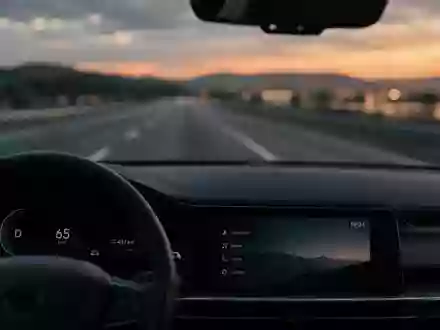 Innenraum eines modernen Autos mit Blick auf eine verschwommene Straße bei Dämmerung. - Foto: über boerse-global.de