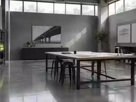 Ein minimalistischer, moderner Industrieraum mit klaren architektonischen Linien und natürlichem Licht. - Foto: über boerse-global.de