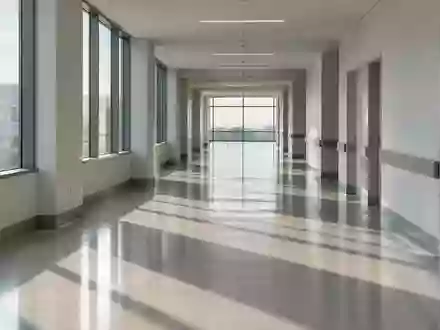 Ein minimalistischer, leerer Krankenhausflur mit sanftem Lichteinfall und klaren architektonischen Linien. - Foto: über boerse-global.de