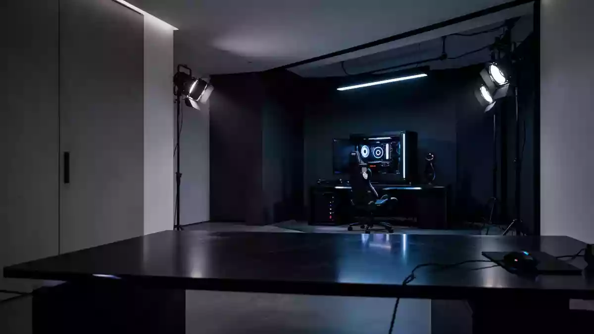 Ein minimalistisch eingerichtetes Gaming-Zimmer mit stimmungsvoller Beleuchtung und dunklen Oberflächen. Illustration mit AI erstellt.