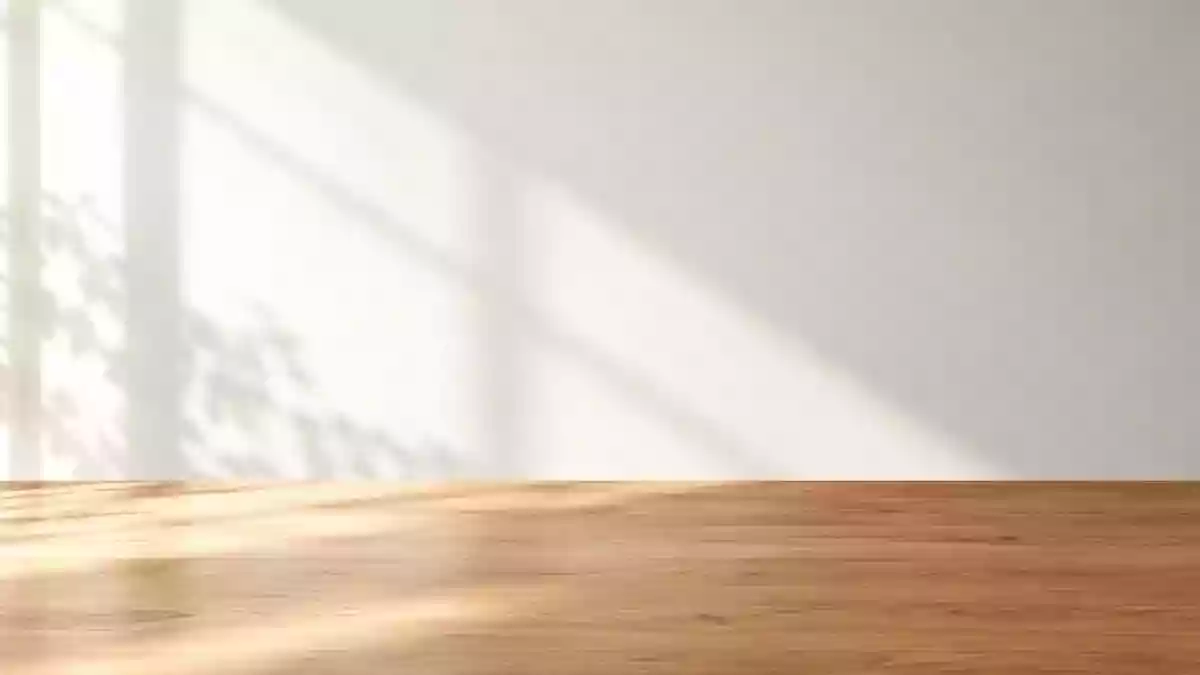 Ein minimalistischer, sonnendurchfluteter Arbeitsbereich mit einem leeren Holztisch vor einer weißen Wand. Illustration mit AI erstellt.