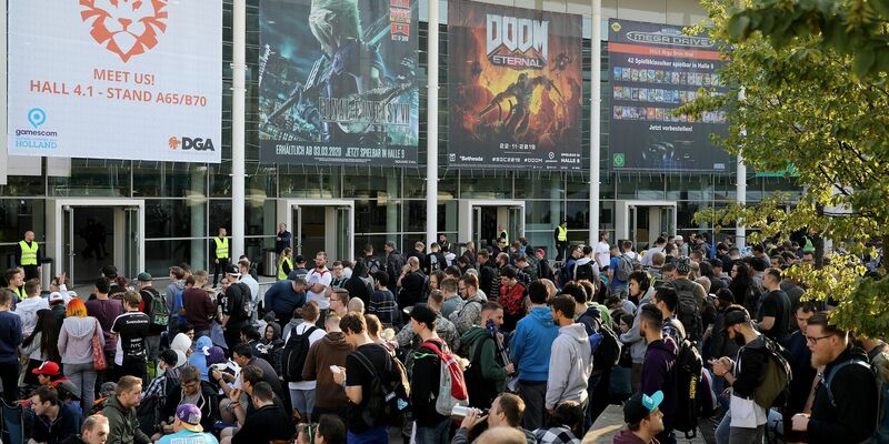 Messebesucher testen ein Computerspiel bei der Gamescom 2022. - Foto: Oliver Berg/dpa
