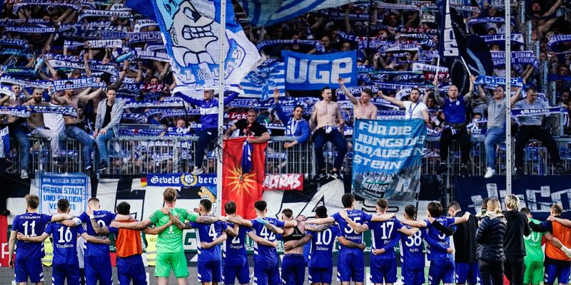 Schalkes Fans entrollen ein großes Transparent. - Foto: Uwe Anspach/dpa