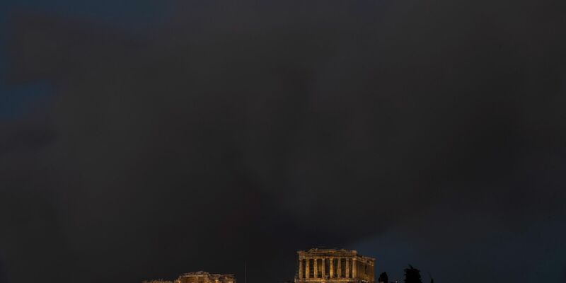 Ein Baum brennt vor einem beschädigten Haus in der Nähe von Loutraki. - Foto: Petros Giannakouris/AP/dpa