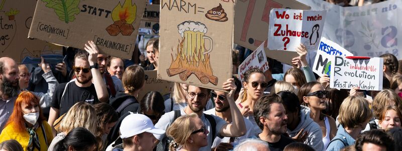 Demonstranten in München nehmen Bezug aufs Oktoberfest - und aufs Bier. - Foto: Sven Hoppe/dpa