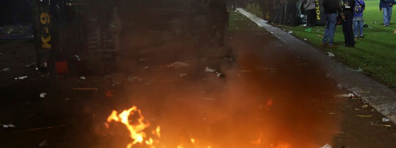 Bei den Ausschreitungen gerieten auch Polizeifahrzeuge in Brand. - Foto: Yudha Prabowo/AP/dpa