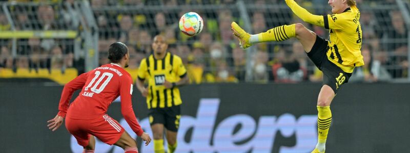 Bayern Münchens Leroy Sané (l) und Dortmunds Julian Brandt kämpfen um den Ball. - Foto: David Inderlied/dpa
