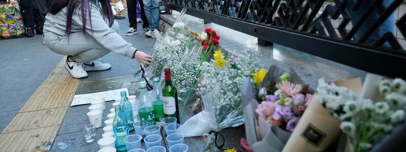 Blumensträuße zum Gedenken an die Opfer der tödlichen Massenpanik in Seoul. - Foto: Ahn Young-Joon/AP/dpa