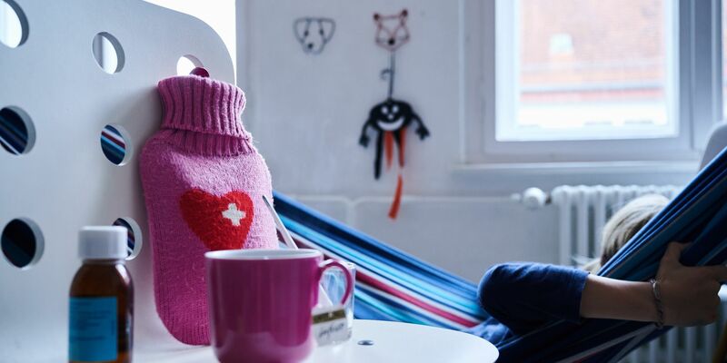 Fieberthermometer, Hustensaft, Wärmflasche und eine Tasse Tee: Die Wellen von Atemwegsinfektionen in Deutschland flachen langsam ab. - Foto: Annette Riedl/dpa