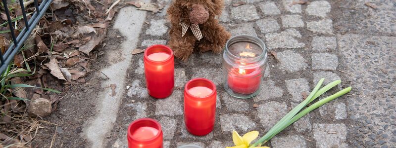 Kerzen und Blumen stehen unweit der Stelle, an der das verletzte Mädchen gefunden wurde. Trotz Reanimation verstarb es. - Foto: Paul Zinken/dpa