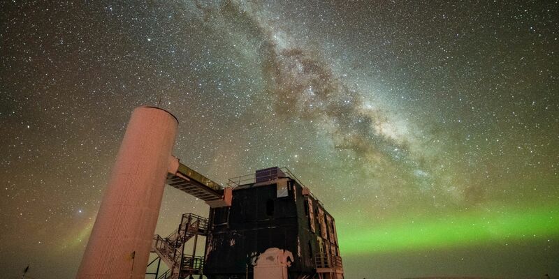 Blick auf das «IceCube»-Labor mit einem sternenklaren Nachthimmel, der die Milchstraße und grüne Polarlichter zeigt. - Foto: Yuya Makino/IceCube/NSF/dpa