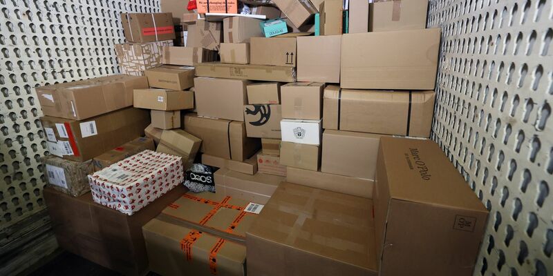 In einer Zustellbasis liefert ein LKW Pakete an, um sie auf die Zustellfahrzeuge aufzuteilen. - Foto: Bernd Wüstneck/dpa