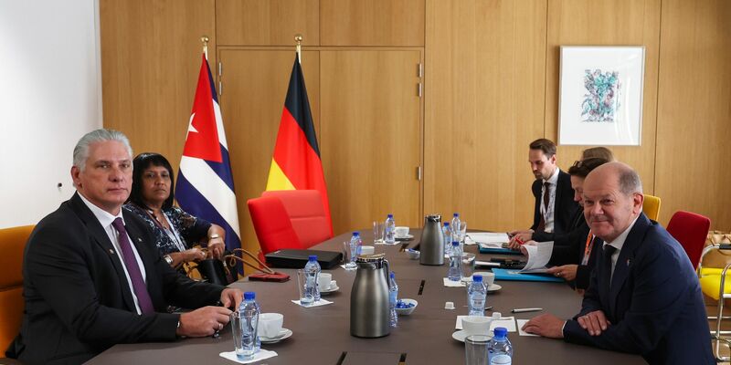 Bundeskanzler Olaf Scholz (r) sitzt mit Miguel Diaz-Canel, Präsident von Kuba, am Tisch. - Foto: Geert Vanden Wijngaert/AP Pool/AP