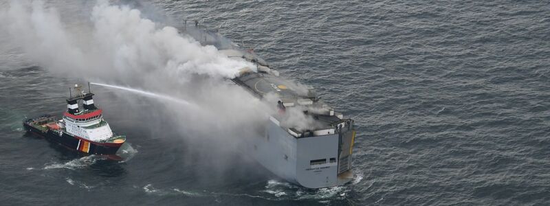 Der brennende Frachter «Fremantle Highway» in der Nordsee. Links im Bild ist der deutsche Notschlepper «Nordic» zu sehen, der das Feuer auf dem Frachter bekämpft. - Foto: Coast Guard Netherlands/dpa