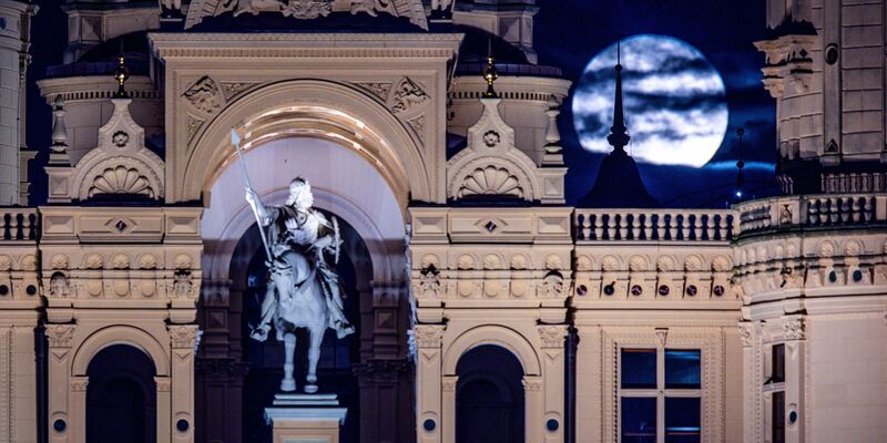 Der Vollmond geht über dem Schweriner Schloss auf. - Foto: Jens Büttner/dpa